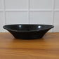 Deep black plastic serving bowl perfect for salads and snacks