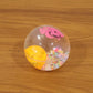 Light-up transparent sensory bouncy ball being used for fun