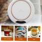 Close-up of the heating plate on the USB mug warmer with an indicator light.