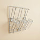 Wall-mounted stainless steel cup rack holding multiple drinkware