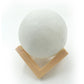 Close-up of the 3D moon lamp showcasing its detailed surface and touch sensor.