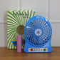 Mini table fan operating quietly on desk providing refreshing airflow