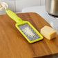 An overhead view of the CookAura grater, highlighting its full length and stainless steel blade.
