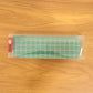 Close-up of high-quality fabric and grid pattern on the green pouch.