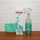 Spray bottle misting concentrated glass cleaner solution on glass surface for cleaning.