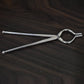 Ganesh 8mm stainless steel tongs, ideal for holding hot utensils, shown from a side angle.