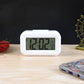 Side view of compact digital alarm clock with temperature sensor