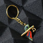 Close-up of Krishna metal keychain featuring flute and peacock feather motif