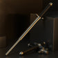 The durable metal shaft of the Folding Walking Stick demonstrating its strength against a brick.