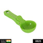 Durable green plastic ice cream scoop ready for serving.