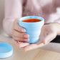 Ergonomic foldable silicone travel cup for comfortable sipping.