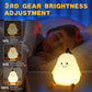 The pear-shaped night light casting a gentle glow in a dim room.