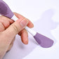 Ergonomic design of the double-headed silicone brush held comfortably for skincare application.