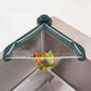 Poravar Kitchen Sink Filter Basket installed in a grey kitchen sink, catching food scraps.