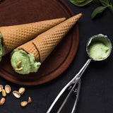 Stainless steel ice cream scoop with an easy-release trigger mechanism.