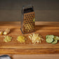 Versatile 5-sided stainless steel grater ideal for grating vegetables and fruits.