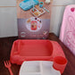 Lifestyle shot of a child interacting happily with the car-shaped dinnerware set.