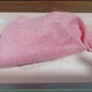 Stack of vibrant microfiber cleaning cloths neatly arranged inside the dispenser box.