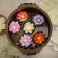 Detailed view of the plastic lotus petals and the LED light mechanism of a floating candle.