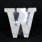 W shaped LED decorative light positioned on shelf as home decor
