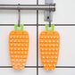 Clean carrot-shaped vegetable brush after washing produce.