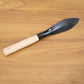 Heavy duty gardening trowel in garden setting used for planting