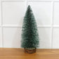 Miniature green Christmas tree with snow effect and sturdy wooden base for festive decor