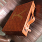 Angled view of the ClassiCarry multi-purpose leather carrying case, highlighting its compact structure.