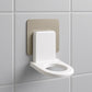 Close-up of a white wall-mounted shampoo holder with a bottle.
