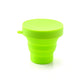 Expanded foldable silicone travel mug, ready for use with a beverage.