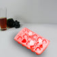 Heart-shaped ice cubes floating in a refreshing drink, adding a lovely touch.