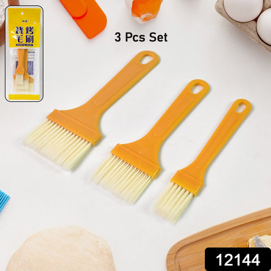 Versatile basting brush set being used to glaze pastries on a baking sheet.