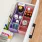 Overhead view of a clear plastic organizer filled with vibrant small craft beads.