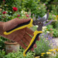 Using garden pruner to cut plant stems with ease
