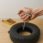Close-up of the tire repair strings and insertion tool.