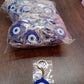 Blue evil eye silicone keychain accessory shown on white background