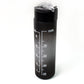 Person holding the sleek black motivational water bottle during a workout session.
