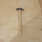 Person using claw hammer to drive a nail in carpentry