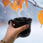 Several durable plastic coffee mugs arranged, showing their smooth finish and vibrant colors.