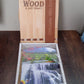 Decorative wooden wall panel with hooks, showing intricate vertical scenery.