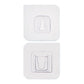 Two white no-drill adhesive hooks mounted on a smooth, clean wall surface.