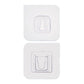 Adhesive wall hooks holding various kitchen utensils, showcasing their versatile use.