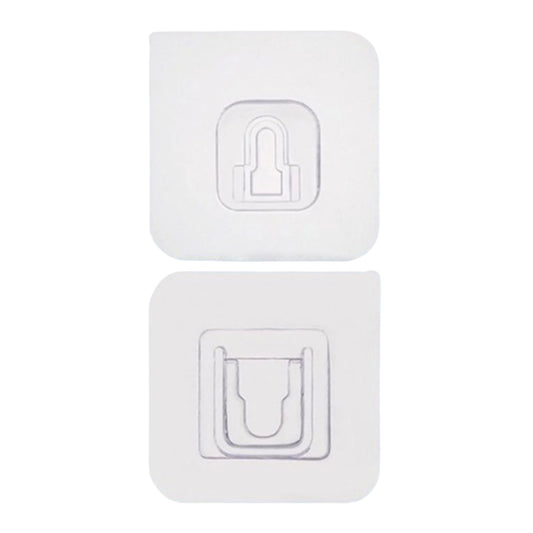 Adhesive wall hooks holding various kitchen utensils, showcasing their versatile use.