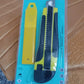 Cutter knife cutting a sheet of paper for precise craft work