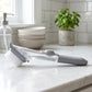 Close-up of soap dispensing mechanism on the dish scrub brush