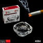 Round crystal glass ashtray, showcasing its clear finish in an office setting.