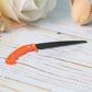 Compact hand pruning saw, ideal for gardening and camping.