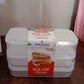 Konvex plastic lunch boxes filled with fresh fruits and vegetables, showcasing meal prep.