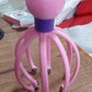 Octopus-shaped electric scalp massager presented on a clean background.
