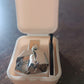 The complete nose hair clipper set, including the trimmer, brush, and protective plastic case.